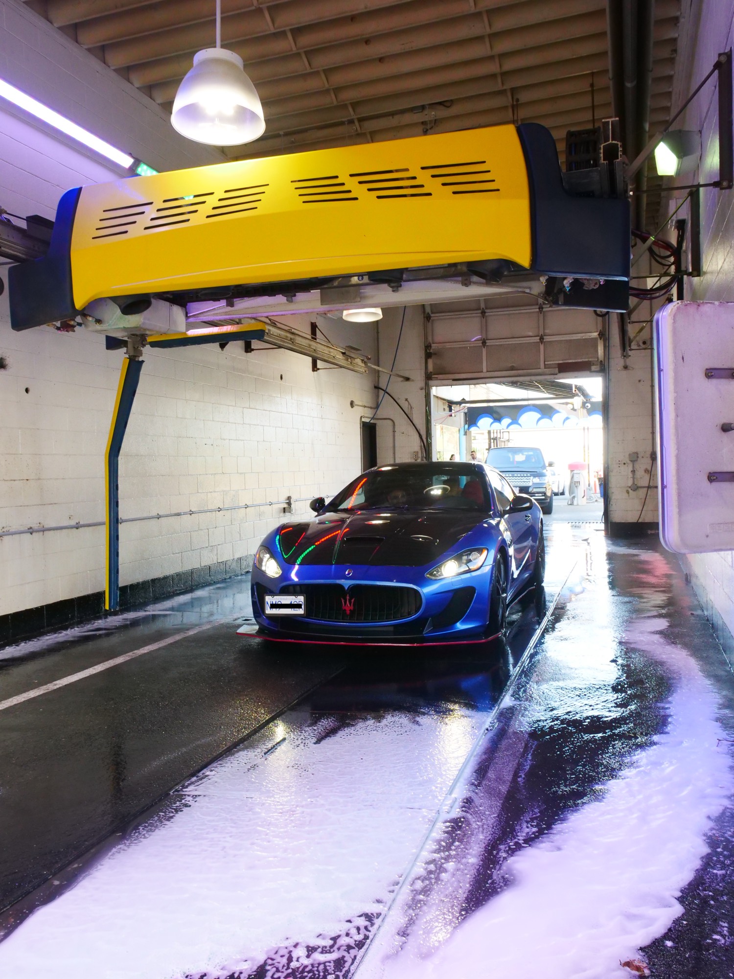 Car being washed in the touchless tunnel at Mr. Clean Auto Care
